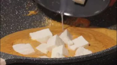 Shahi paneer in rich creamy gravy garnished with cream
